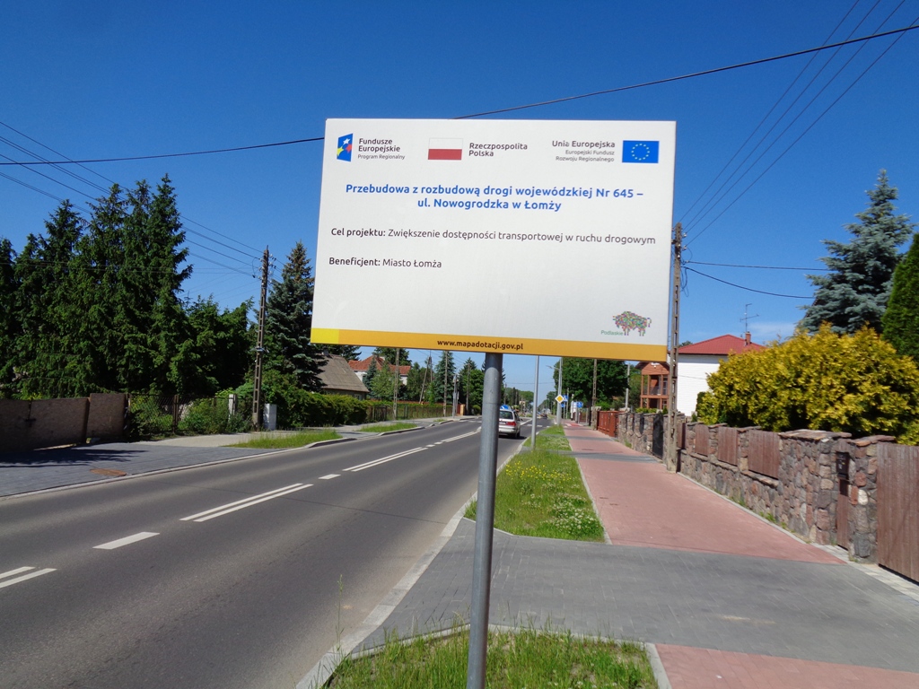 Tablica informacyjna stoi przy zmodernizowanej ulicy Nowogrodzkiej w Łomży 
